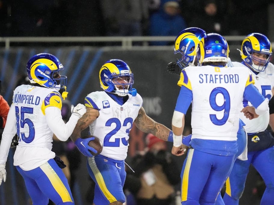 Rams running back Kyren Williams (23) celebrates his touchdown run with teammates Konata Mumpfield (15), Matthew Stafford (9), Warren McClendon Jr.,  back, and Coleman Shelton (65) during an NFL football divisional playoff game Sunday in Chicago.