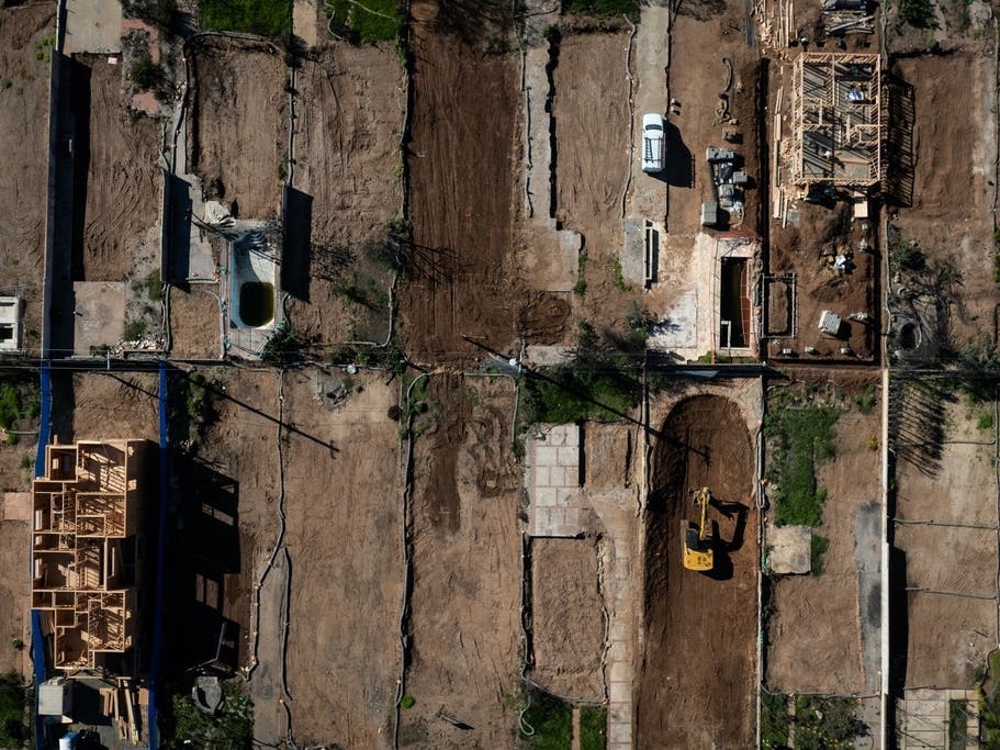 An aerial view shows houses being rebuilt on cleared lots months after the Palisades Fire, Dec. 5, 2025, in the Pacific Palisades neighborhood of Los Angeles. 
