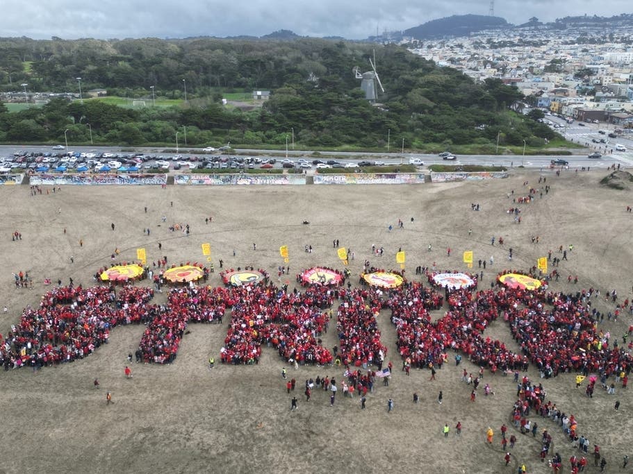 Hundreds of San Francisco teachers form a human banner spelling "STRIKE" on Ocean Beach on the third day of a district-wide strike over wages, benefits and other issues. 