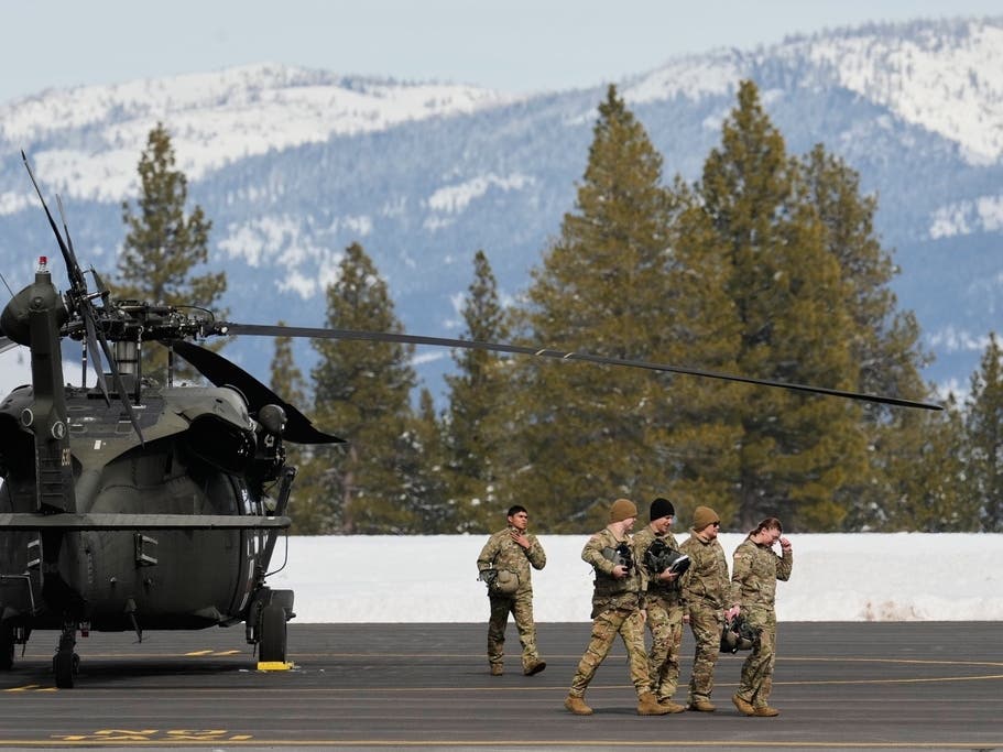 U.S. Army soldiers exit a Black Hawk at the Truckee Tahoe Airport in Truckee, Calif., Saturday, Feb. 21, 2026, after aiding in recovery efforts for a group of skiers who went missing during a deadly avalanche.
