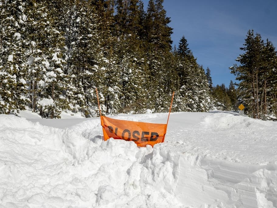 A closed sign is partially buried at the entrance to the Castle Peak trailhead in Soda Springs, Calif., Friday, Feb. 20, 2026. 