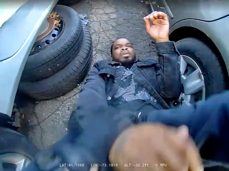 In this photo taken from video released by the Bridgeport Police Department, Dyshan Best looks up at Bridgeport Police officer Yoon Heo after being shot by Heo during a chase, Monday, March 31, 2025, in Bridgeport.