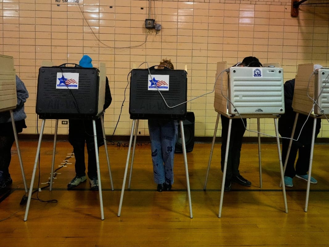 Democratic candidate for Congress, Kat Abughazaleh, center, casts her vote in a primary election for the upcoming midterms, in Chicago, Tuesday, March 17, 2026.