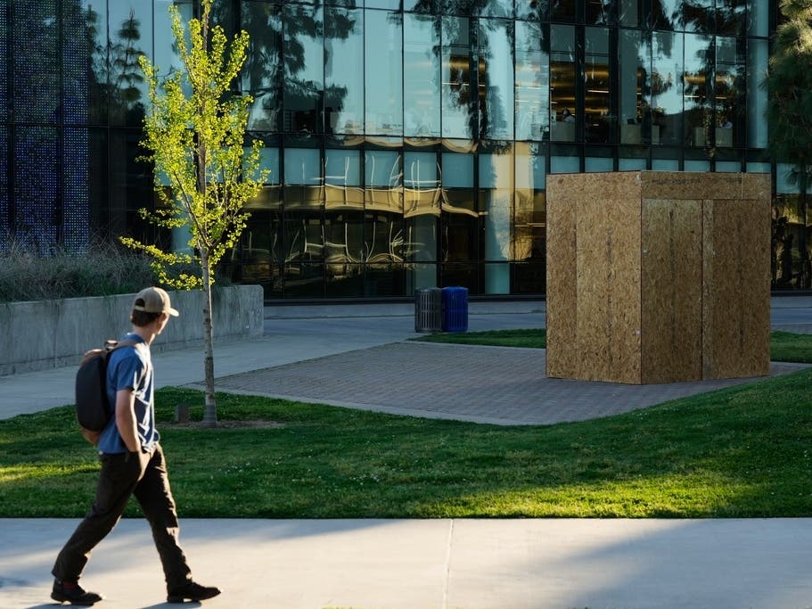 A student looks toward a plywood box covering a statue of César Chavez at California State University, Fresno in Fresno, Calif., Wednesday, March 18, 2026. 