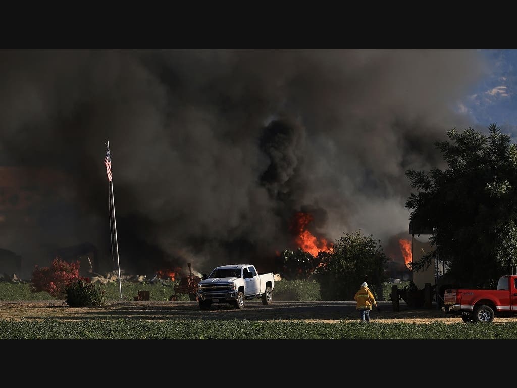 Smoke and flames rise during a fireworks warehouse explosion near Esparto, Calif., Tuesday, July 1, 2025. 