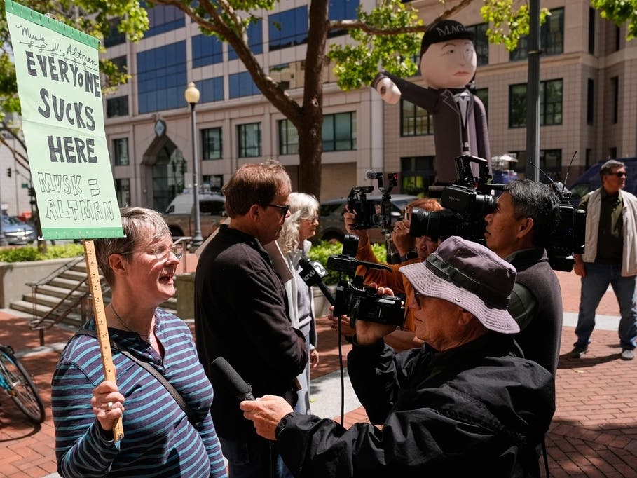 Protesters are interviewed by media outside the U.S. District Court, in Oakland, Calif., Monday, April 27, 2026. 