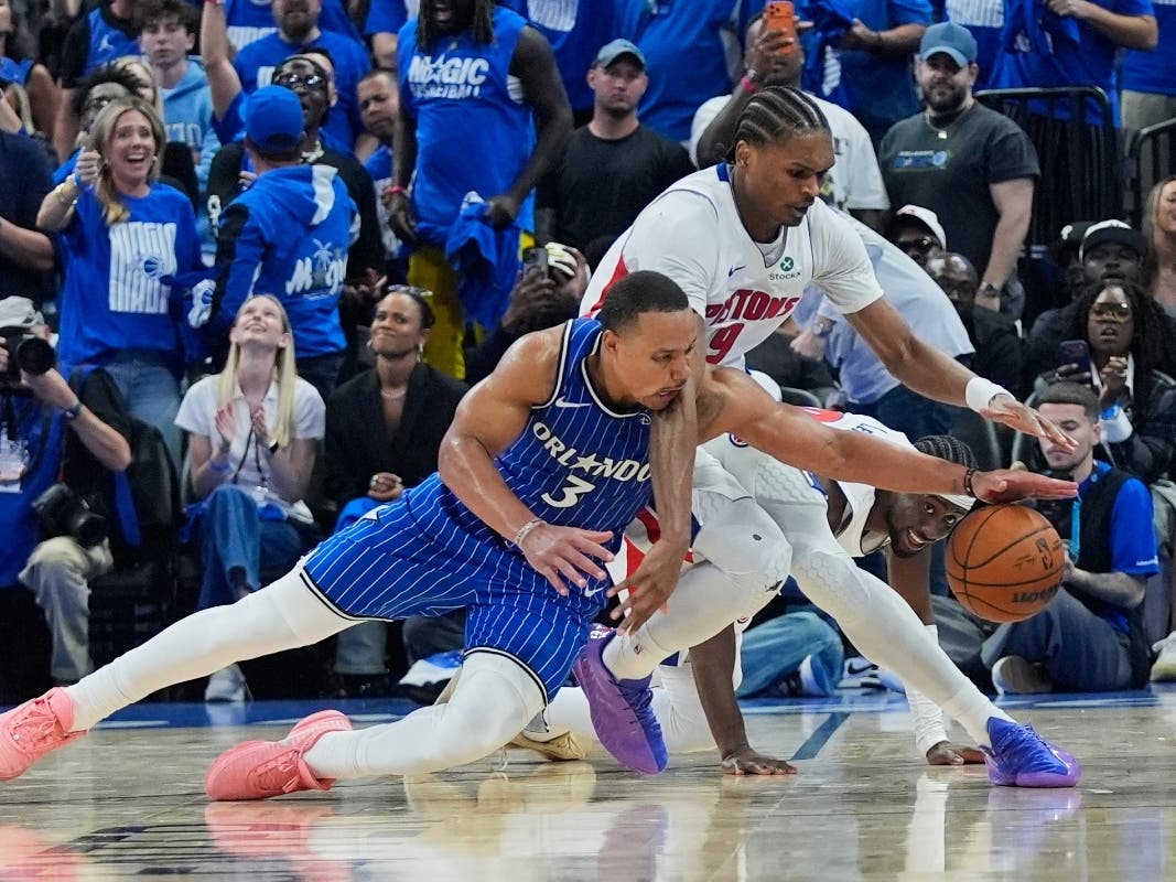 Orlando Magic guard Desmond Bane (3) goes after a loose ball against Detroit Pistons guard Ausar Thompson during the second half in Game 4 of a first-round NBA basketball playoff series, Monday, April 27, 2026, in Orlando.