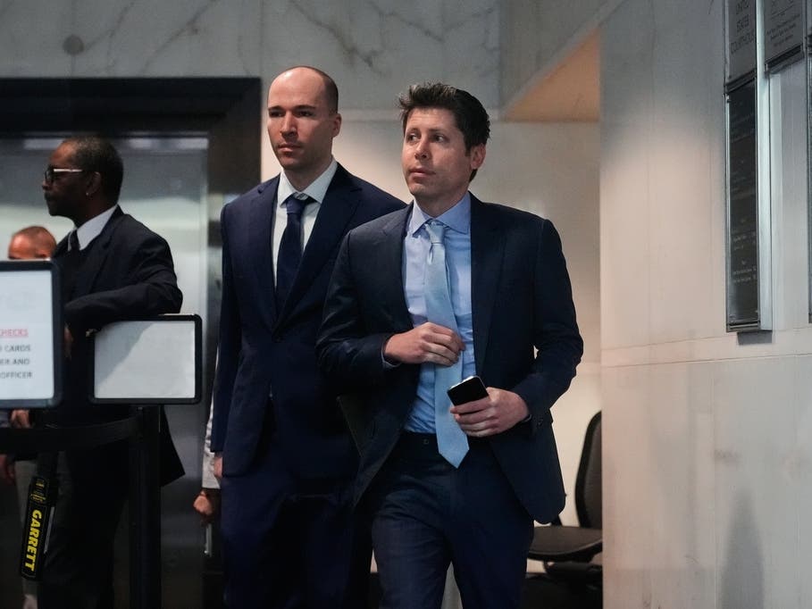Sam Altman, right, and OpenAI president Greg Brockman, center, arrive at the U.S. District Court in Oakland, Calif., Thursday, April 30, 2026. 
