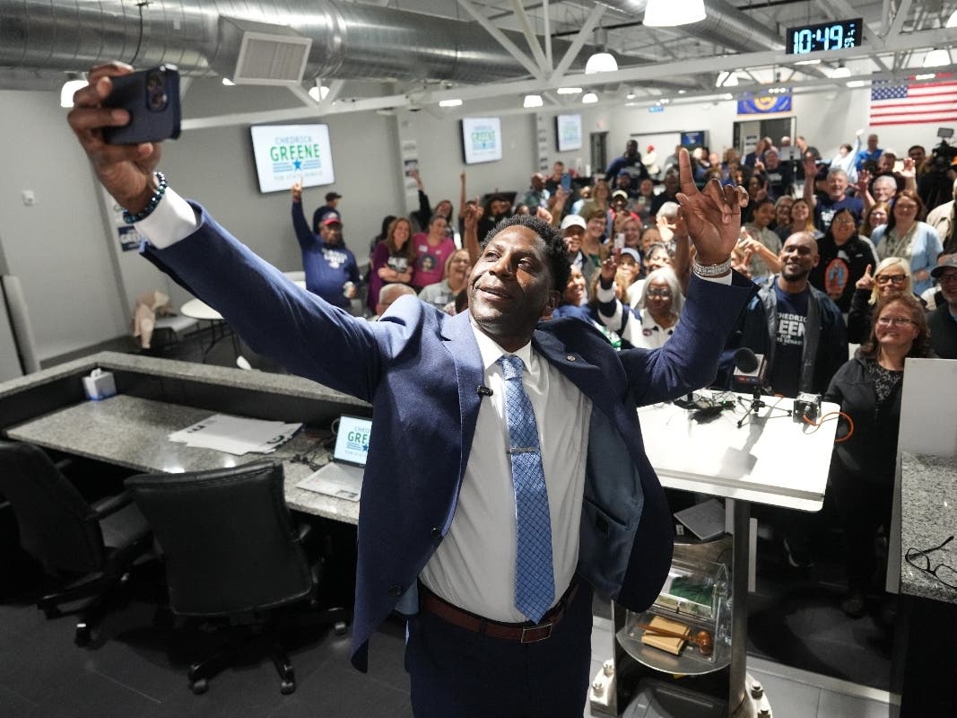 Democrat Chedrick Greene takes a selfie with supporters after speaking Tuesday, May 5, 2026, in Saginaw, Mich.