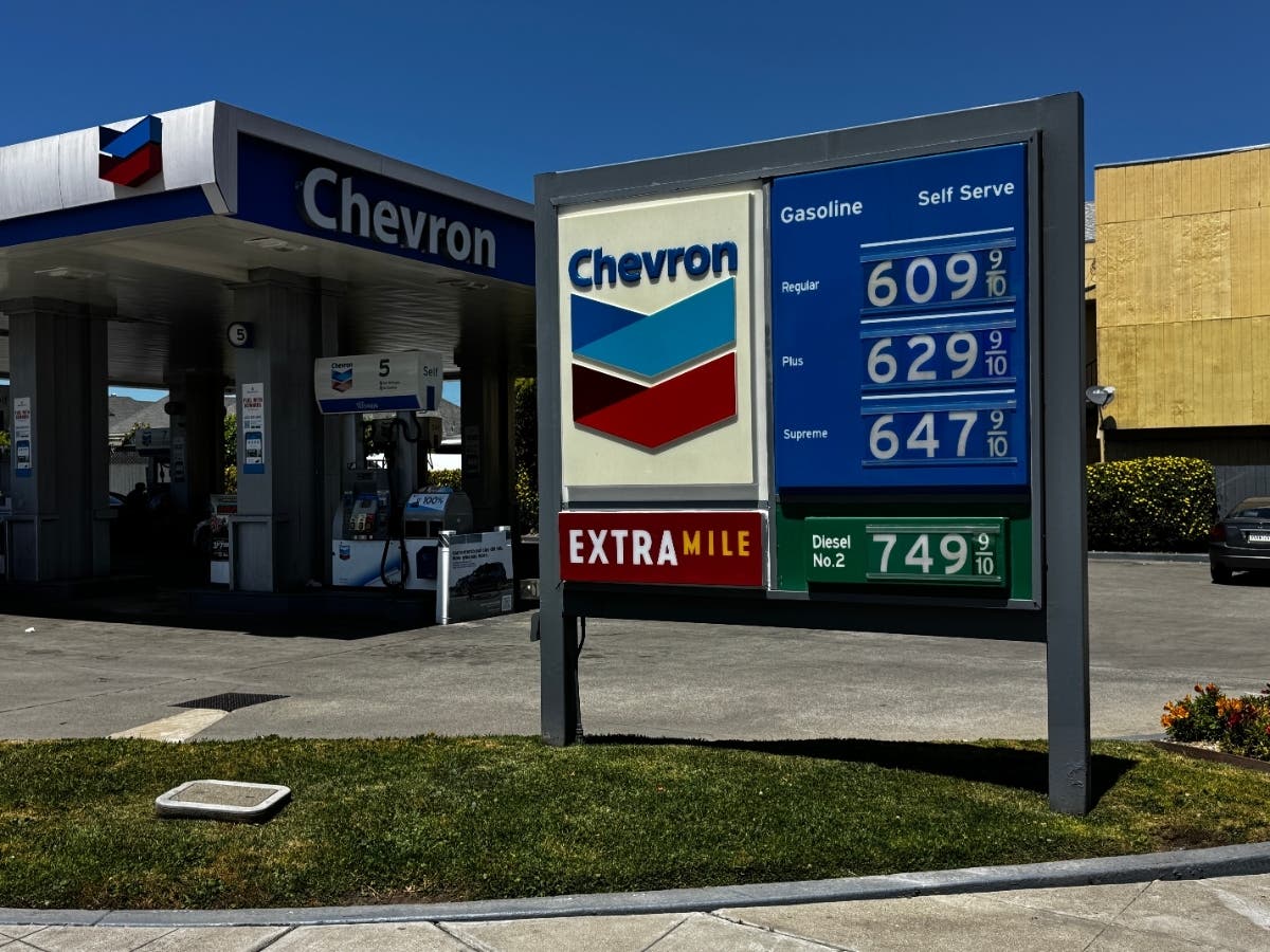 A billboard shows gas prices at a Chevron gas station in Alameda, Calif., on Thursday, May 21, 2026, where company signs blame Sacramento policies for high fuel costs.