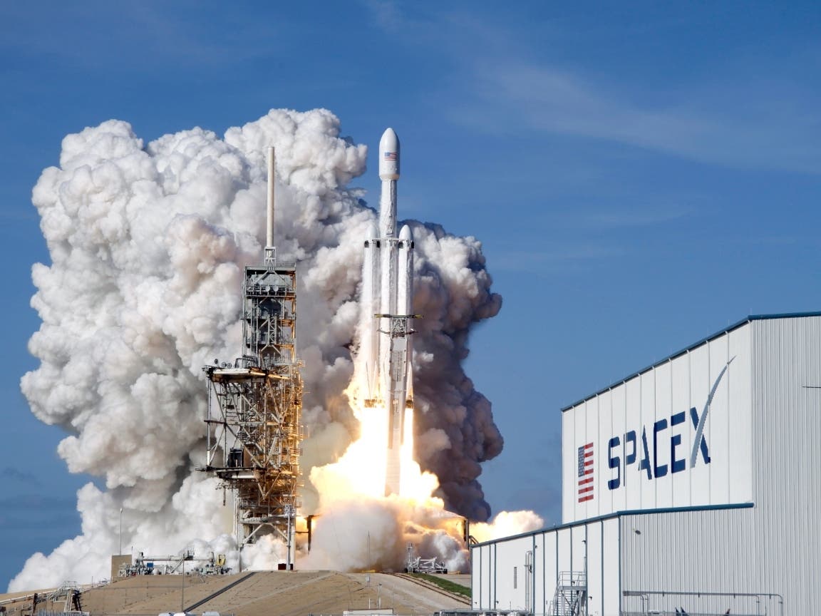 A Falcon 9 SpaceX heavy rocket lifts off from pad 39A at the Kennedy Space Center in Cape Canaveral, Fla., Tuesday, Feb. 6, 2018. 