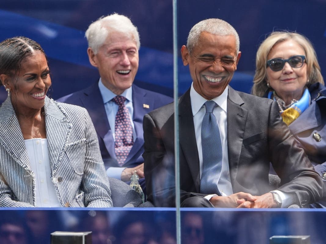 Former President Barack Obama, right, shares a laugh with former First Lady Michelle Obama, left, on stage during the dedication ceremony for the Obama Presidential Center, Thursday in Chicago.