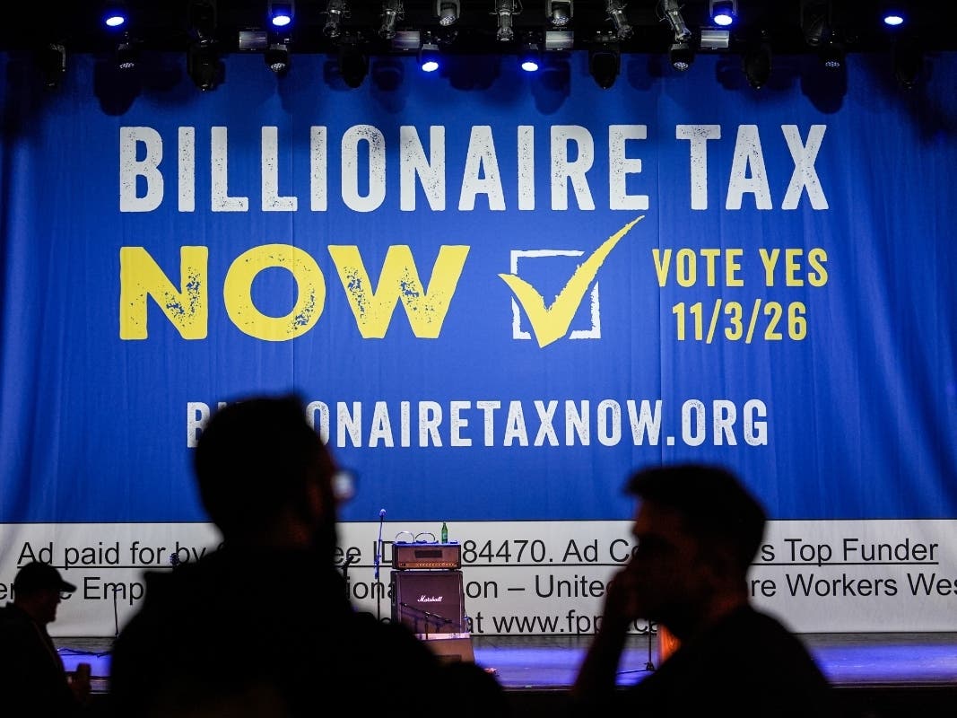 A large banner is seen at a campaign event for a proposed "billionaires tax" in Los Angeles on Feb. 18, 2026.