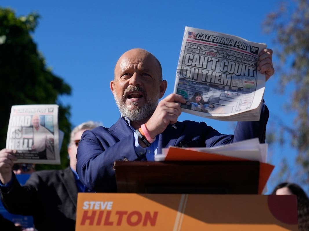 California Republican gubernatorial candidate Steve Hilton holds a newspaper while speaking at a news conference at the San Mateo County elections office Friday, June 5, 2026, in San Mateo, Calif.