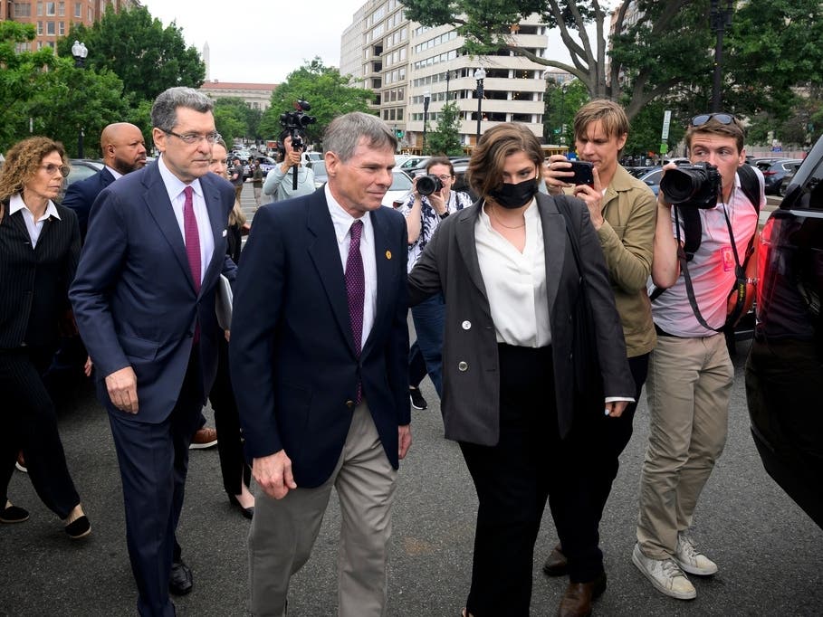 Former Olympic canoeist David Hearn, center, and his attorney Norman Eisen, left, walk to a car following a court appearance, where he pleaded not guilty to allegedly damaging the Lincoln Memorial Reflecting Pool.