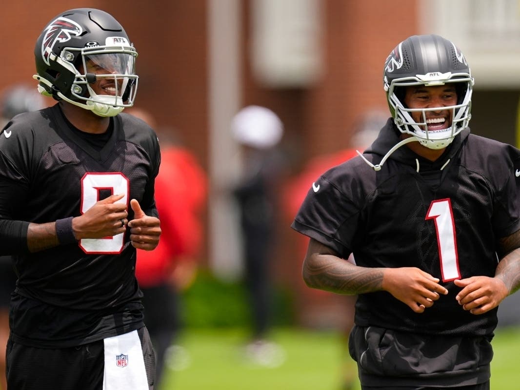 Atlanta Falcons quarterback's Michael Penix Jr. and Tua Tagovailoa (1) move during an NFL football practice, Wednesday, May 27, 2026, in Flowery Branch, Ga