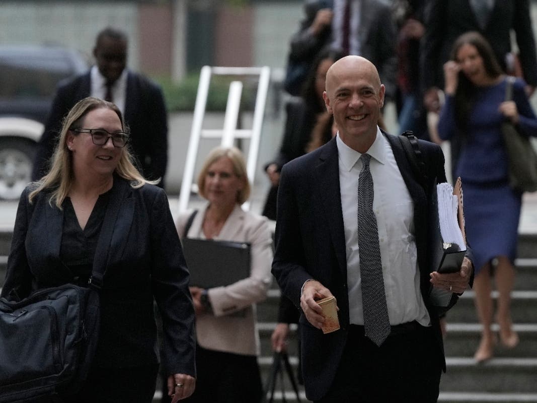 Attorney Paul W. Schmidt, representing Meta, right, arrives at a Federal Courthouse Wednesday, Aug. 12, 2026, in Oakland, Calif.