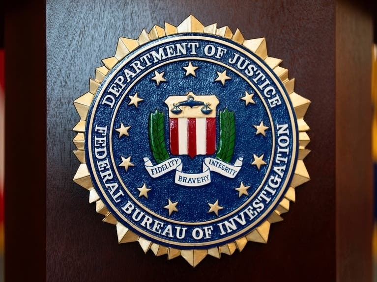 An FBI seal is displayed on a podium before a news conference at the field office in Portland, Ore., Jan. 16, 2025.