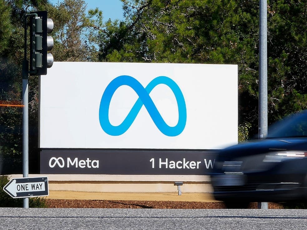 A car passes Facebook's new Meta logo on a sign at the company headquarters on Oct. 28, 2021, in Menlo Park, Calif.
