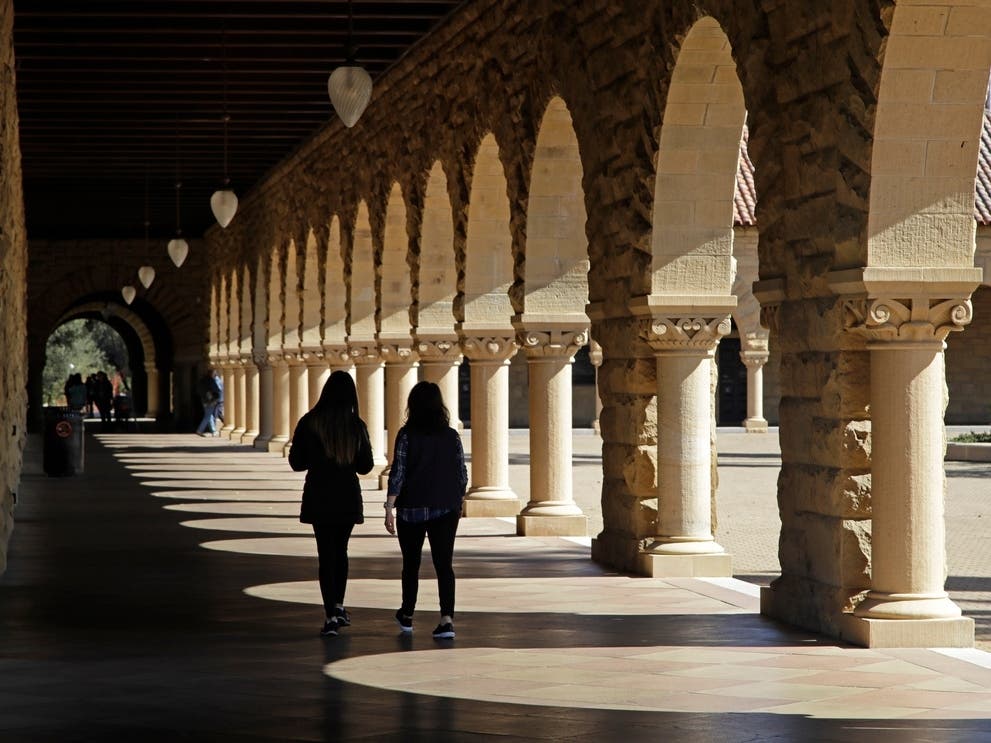 Students walk through the Stanford University campus, March 14, 2019, in Santa Clara, Calif.