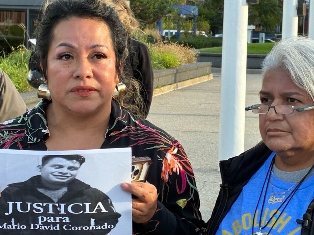 In this photo taken with a smartphone, Karla Barberi, left, and Gema Lowe demand justice Thursday for Mario David Coronado Juarez, who died in a car crash while fleeing ICE officers Sunday, Sept. 20, in Grand Rapids.