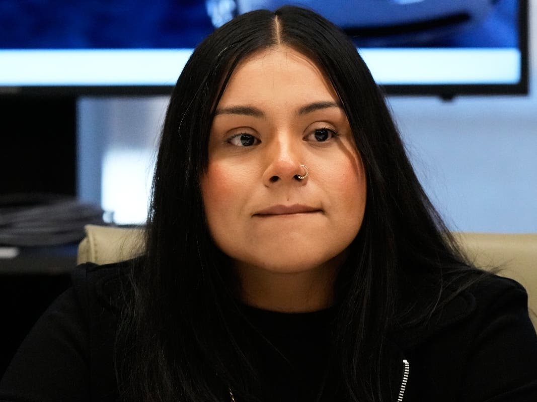 Marimar Martinez, a Chicago woman who was shot by a Border Patrol agent last year, listens to attorney Christopher Parente at a press conference Monday in Chicago.