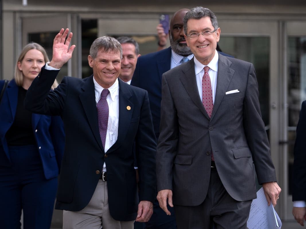 Former Olympic canoeist David Hearn (left) and his attorney, Norm Eisen (right), leave the District of Columbia Courthouse following a hearing on his dismissal of charges for allegedly damaging the Reflecting Pool. 