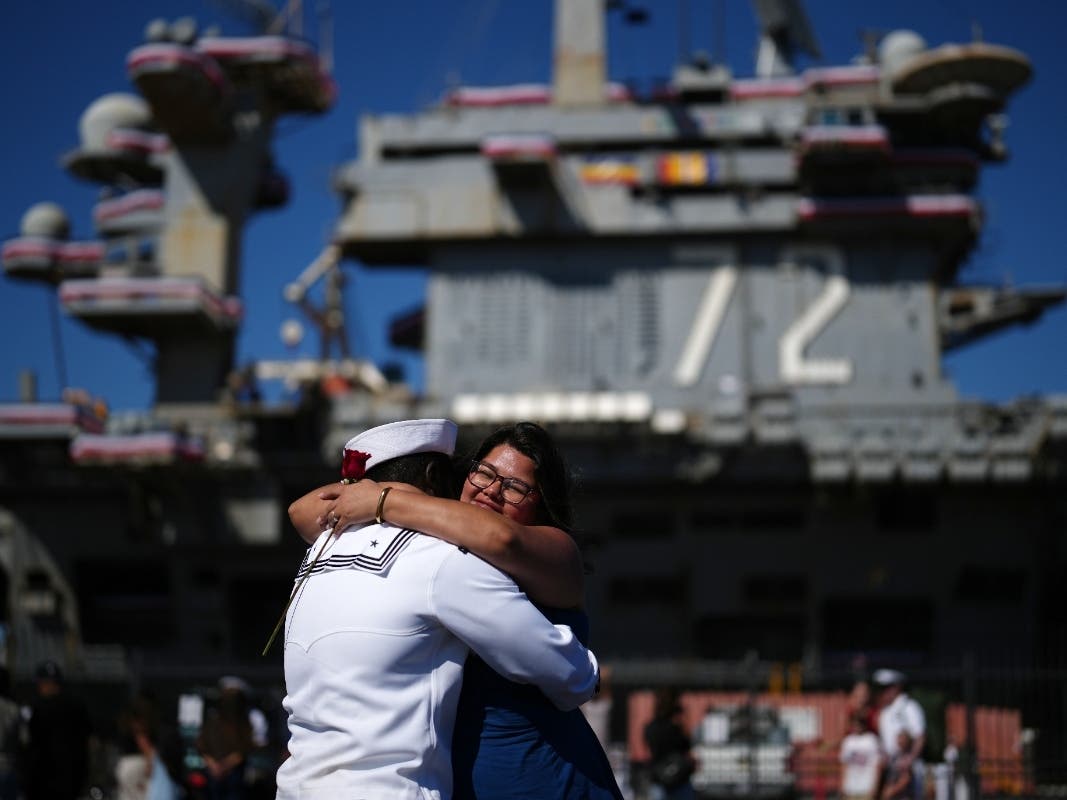 Sailor Lawrence Kwakye, left, greets his wife, Wanda Kwakye after the USS Abraham Lincoln aircraft carrier returned to Naval Air Station North Island after deployment Thursday, Oct. 8, 2026, in Coronado, Calif.