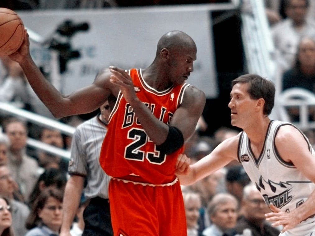 Chicago Bulls' Michael Jordan pulls the ball out of reach of Utah Jazz guard Jeff Hornacek during third quarter action in Game 2 of the NBA Finals in Salt Lake City, June 5, 1998.