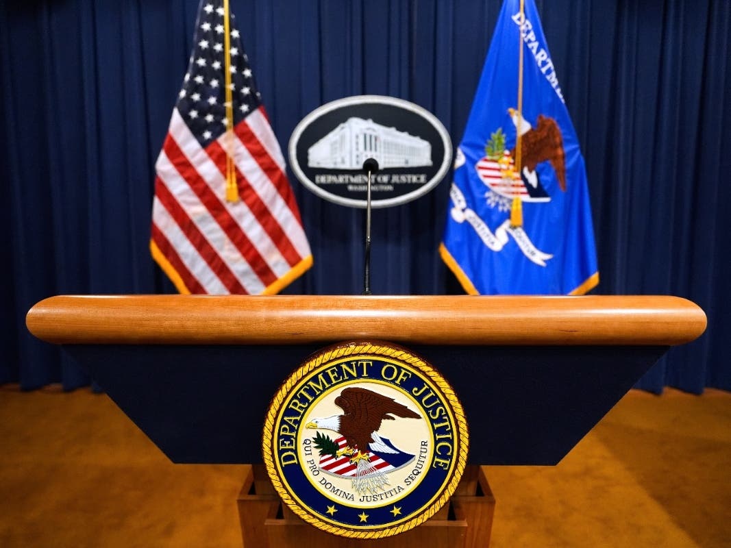 The U.S. Department of Justice logo is seen on a podium before a press conference, May 6, 2025, at the Justice Department in Washington.