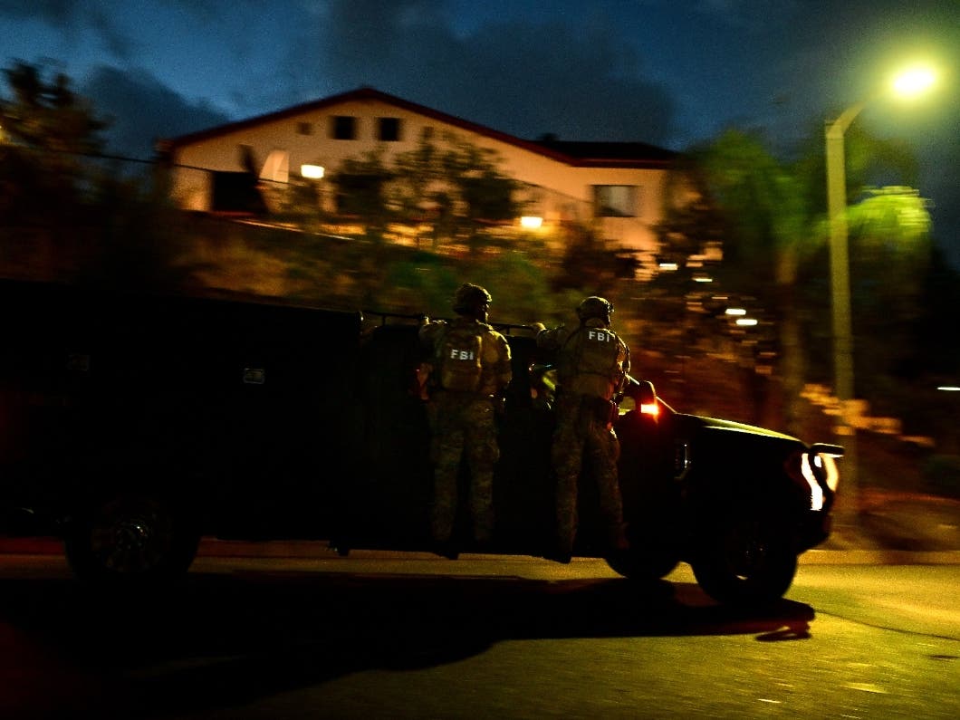 Federal agents arrive to a suspect's house during a raid related to health care fraud in the early morning on Thursday, Oct. 22, 2026, in Los Angeles.