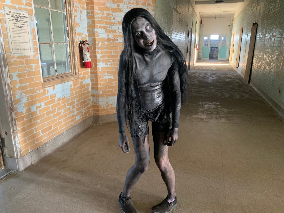 Lexi Carter, the lead makeup artist and a scare actor at Eloise Asylum, stands in the hallway on an upper floor at Eloise Asylum that treated patients when the building was a psychiatric hospital, Thursday, Sept. 24, 2026, in Westland, Mich.