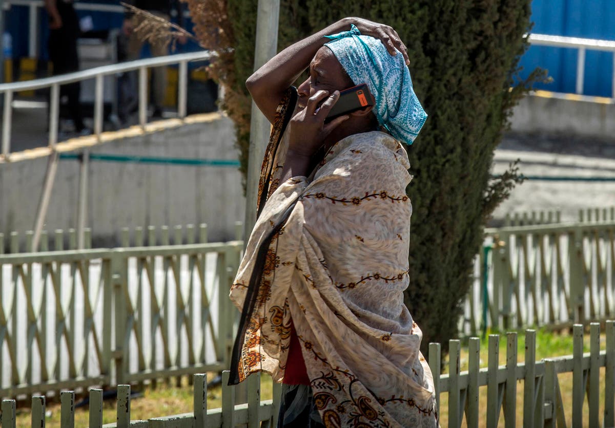 A family member of a victim involved in a plane crash talks on a mobile phone at Addis Ababa international airport.