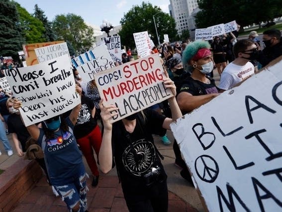 Participants carry placards during a protest outside the state Capitol over the death of George Floyd. 
