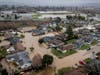 Flooding from huge amounts of rain are seen in a neighborhood off of Holohan Road near Watsonville, California on Monday.