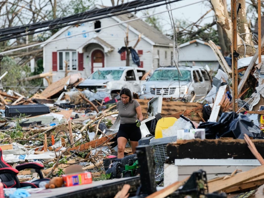 A woman walks among debris after a tornado struck Monday, July 27, 2026, in Menasha, WI. 