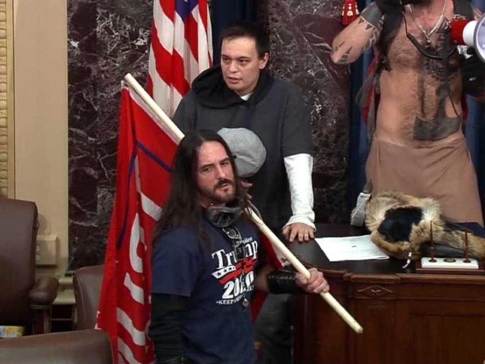 Paul Allard Hodgkins, 38, of Tampa, front, stands in the well on the floor of the U.S. Senate on Jan. 6, 2021, at the Capitol in Washington.