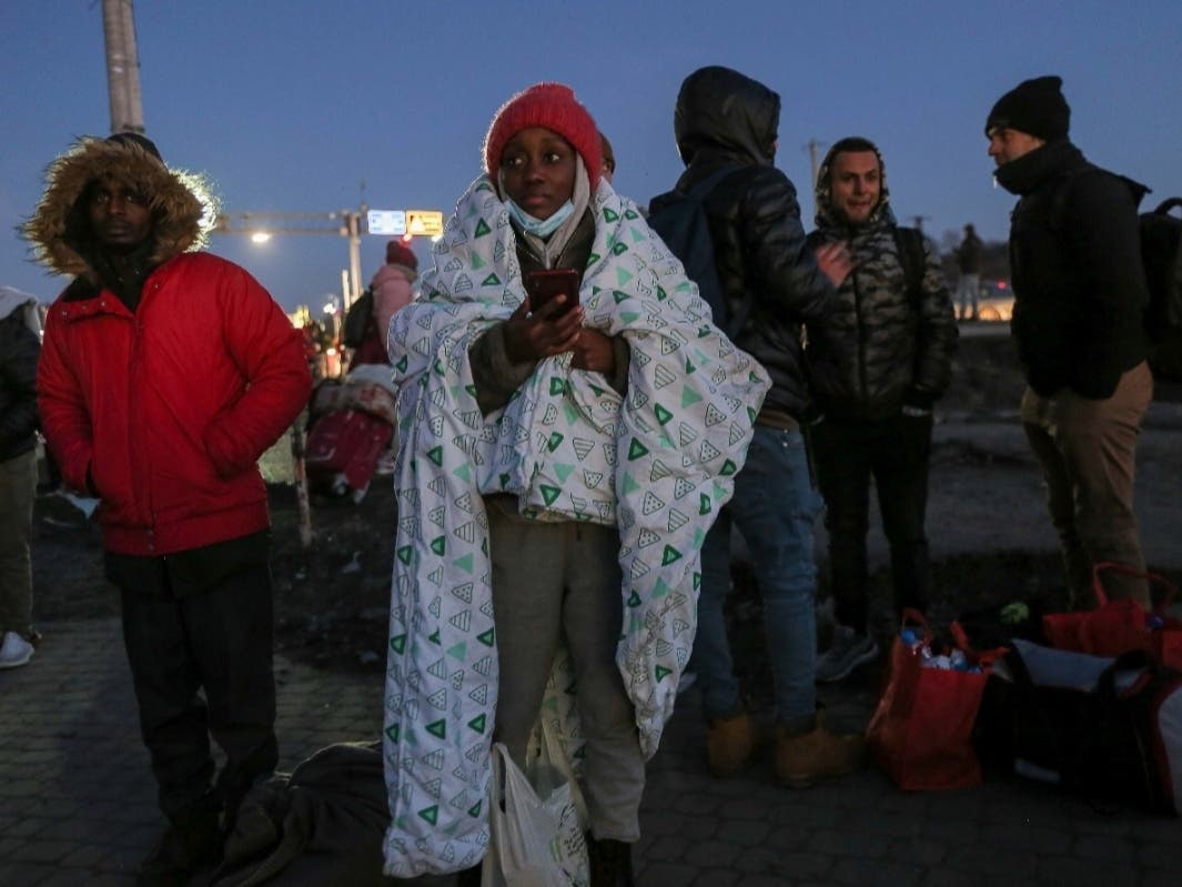 A student covers herself in blanket at the Medyka border crossing after fleeing from the Ukraine, in Poland, Monday, Feb. 28. The head of the United Nations refugee agency says more than a half a million people had fled Ukraine since Russia's invasion.
