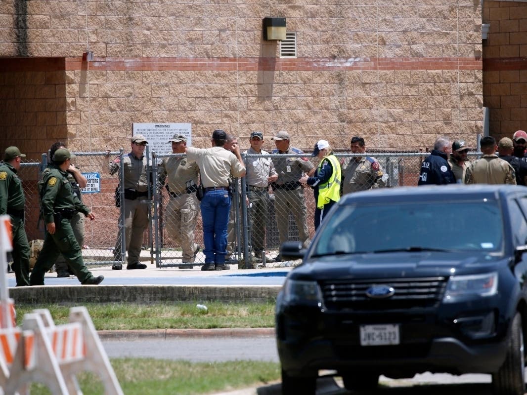 Law enforcement, and other first responders, gather outside Robb Elementary School following a shooting, Tuesday, May 24, 2022, in Uvalde, Texas.