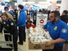 Transportation Security Administration (TSA) workers collect cheesesteaks for their coworkers that were made for a Guinness World Record attempt on National Cheesesteak Day at Philadelphia International Airport, Tuesday, March 24, 2026, in Philadelphia.