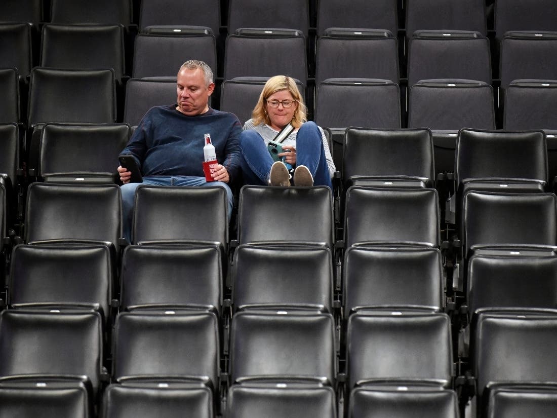 Basketball fans leave Chesapeake Energy Arena Wednesday night after it is announced that an NBA basketball game between Oklahoma City Thunder and Utah Jazz in Oklahoma City has been postponed.