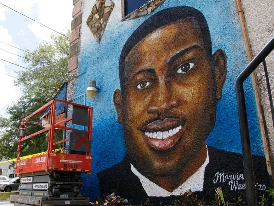 In this May 17, 2020, file photo, a recently painted mural of Ahmaud Arbery is on display in Brunswick, Ga., where the 25-year-old man was shot and killed in February. It was painted by Miami artist Marvin Weeks.