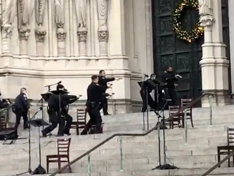 An image of NYPD officers approaching a shooter at Cathedral of St. John the Divine on Sunday.