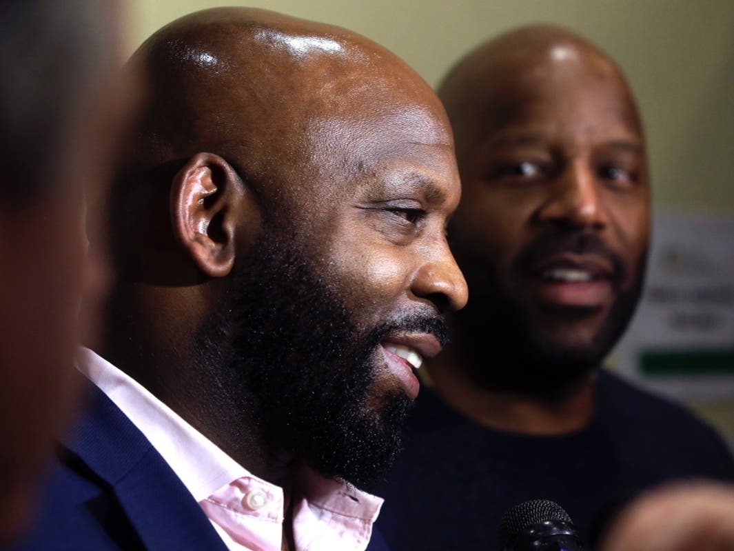 Entrepreneurs Kevin Hart, of Randolph, (left) and Kobie Evans, of Boston, speak to reporters after attending a meeting of the Massachusetts Cannabis Control Commission, Thursday in Worcester.