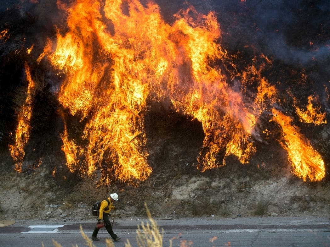 Flames from a backfire, lit by firefighters to stop the Saddleridge Fire from spreading, burn a hillside in Newhall, Calif., on Friday, Oct. 11, 2019. An aggressive wildfire in Southern California seared its way through dry vegetation Friday and spread qu