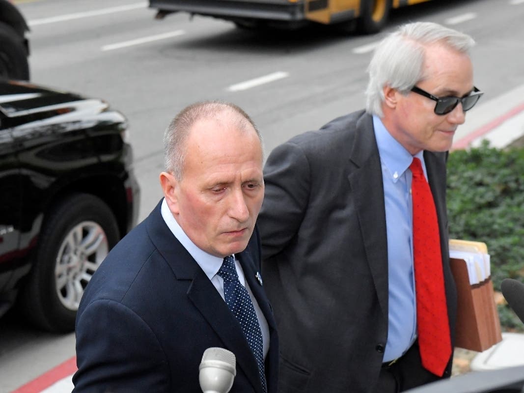 L. Lin Wood, right, attorney for plaintiff, British cave expert Vernon Unsworth, left, arrives for the trial against Tesla CEO Elon Musk at U.S. District Court Tuesday, Dec. 3, 2019, in Los Angeles. Musk is going on trial for his troublesome tweets.