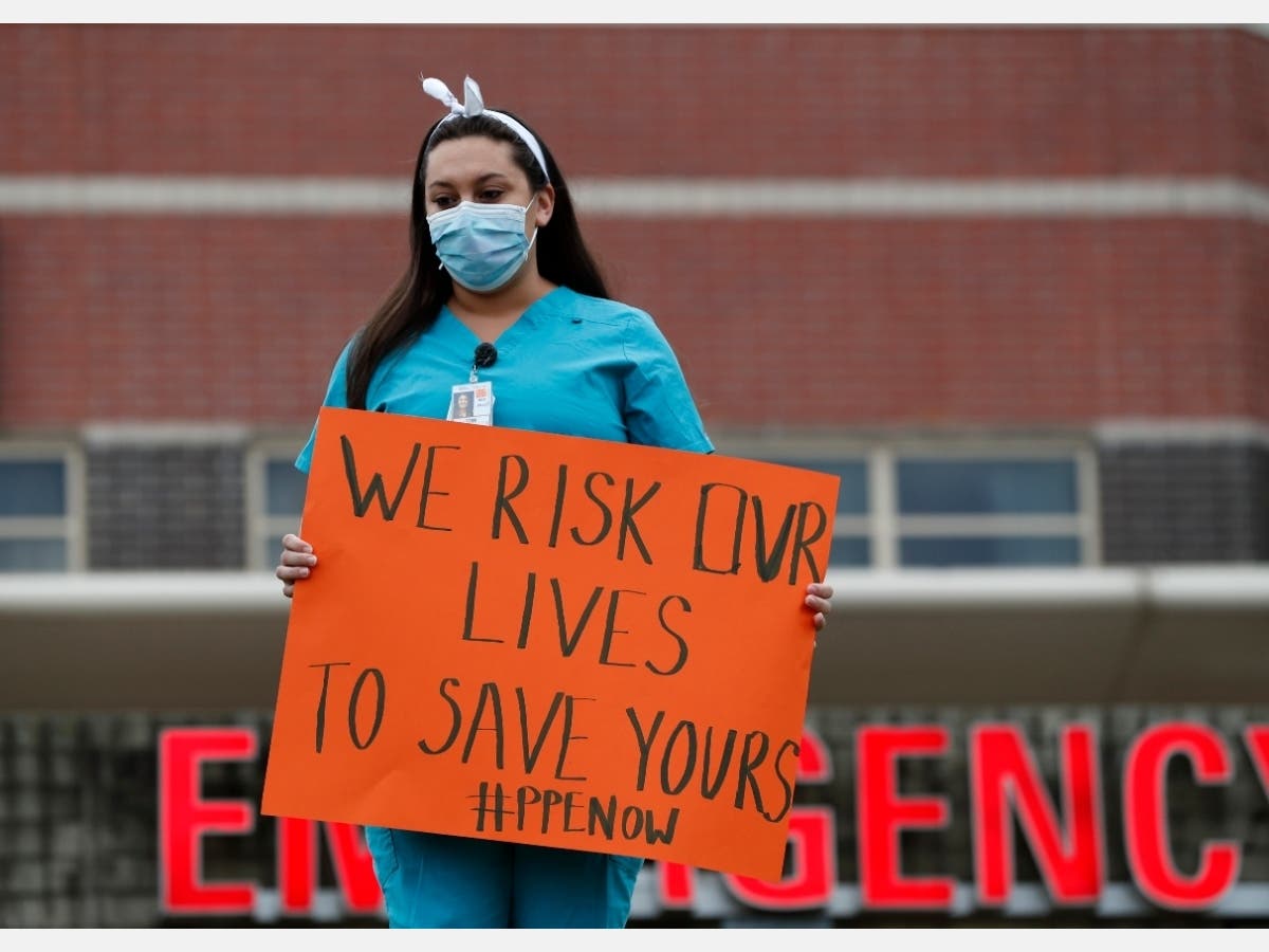 File Photo: A nurse demonstrates outside a hospital in New York, Saturday, March 28, 2020, demanding more personal protective equipment for medical staff treating coronavirus patients.