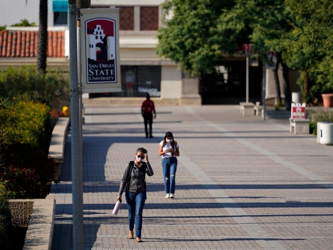 FILE - In this Sept. 2, 2020, file photo, people walk on campus at San Diego State University in San Diego.