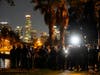 Los Angeles police officers move in to arrest demonstrators in the Echo Park Lake homeless encampment in Los Angeles late Wednesday, March 24, 2021.