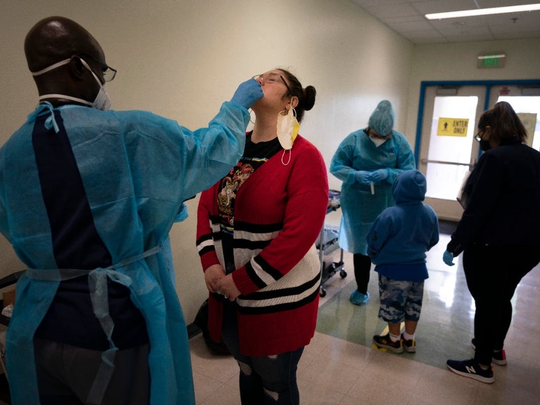 School employee Amanda Anguiano gets tested for COVID-19 at Maurice Sendak Elementary School in Los Angeles.